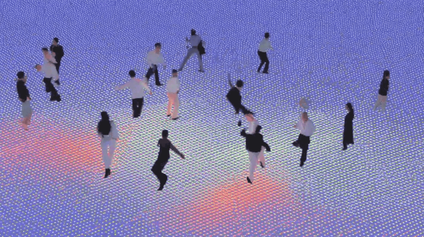 People dancing on a glowing disco floor